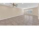 Spacious living room with tile flooring, neutral walls, and bright natural light from shuttered windows at 3064 Bicentennial Pkwy, Henderson, NV 89044