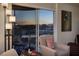 Balcony area with comfortable seating and stunning views of the city skyline at sunset at 3111 Bel Air Dr # 20H, Las Vegas, NV 89109