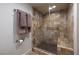 Modern tiled shower with glass doors, a built-in seat, and a hand-held shower head at 3111 Bel Air Dr # 20H, Las Vegas, NV 89109