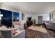 Inviting living room with a cozy seating area, wooden floors, balcony access, and panoramic city views at 3111 Bel Air Dr # 20H, Las Vegas, NV 89109