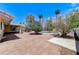 Large backyard featuring a patio, trees, and a pool, perfect for outdoor entertaining and relaxation at 3360 Paso Andres St, Las Vegas, NV 89146