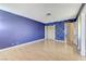 Bedroom features laminate floors, painted accent wall, and a closet at 3360 Paso Andres St, Las Vegas, NV 89146