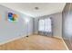 Bedroom features laminate floors, a window, and artist painted accent wall at 3360 Paso Andres St, Las Vegas, NV 89146