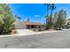 Charming single story home featuring a spacious driveway, xeriscaped front yard, and palm trees at 3360 Paso Andres St, Las Vegas, NV 89146