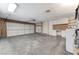 Spacious garage with a large door, laundry area, and plenty of room for parking and storage at 3360 Paso Andres St, Las Vegas, NV 89146