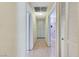 Hallway with laminate floors, neutral walls, closet storage and access to the other rooms at 3360 Paso Andres St, Las Vegas, NV 89146