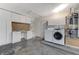 Functional laundry room features a washer, dryer, water heater, and ample storage cabinets and counter space at 3360 Paso Andres St, Las Vegas, NV 89146