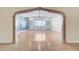 Bright living room featuring wood floors and a large archway at 3360 Paso Andres St, Las Vegas, NV 89146