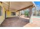Covered patio area with a ceiling fan, offering a relaxing view of the landscaped backyard and pool at 3360 Paso Andres St, Las Vegas, NV 89146