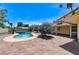 Brick patio featuring a pool with spa and outdoor grill area in a well-maintained backyard at 3360 Paso Andres St, Las Vegas, NV 89146