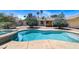 Backyard featuring a turquoise in-ground pool with an attached spa and brick patio at 3360 Paso Andres St, Las Vegas, NV 89146