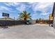 Large backyard boasts a brick patio, mature palm tree, basketball hoop, and storage shed at 3417 Lillis Cir, North Las Vegas, NV 89030