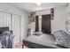 Simple bedroom with bed frame, posters, closet, and a wall-mounted skateboard at 3417 Lillis Cir, North Las Vegas, NV 89030