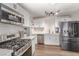 Modern kitchen features stainless steel appliances, gas range, white cabinets, and wood-look floors at 3417 Lillis Cir, North Las Vegas, NV 89030