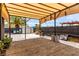 Spacious brick patio with shaded pergola, shed, palm tree, and outdoor seating provides a backyard oasis at 3417 Lillis Cir, North Las Vegas, NV 89030
