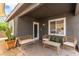 Welcoming front porch with cozy seating offers a relaxing outdoor space with textured walls at 3417 Lillis Cir, North Las Vegas, NV 89030