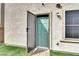 Back door with a screen leading to artificial turf, complemented by an exterior security light at 382 Gracious Way, Henderson, NV 89011