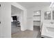 Bathroom area featuring dual sinks, a walk-in closet, and an adjacent office space at 382 Gracious Way, Henderson, NV 89011
