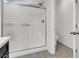 Modern bathroom with tiled shower with glass sliding doors and white tile at 382 Gracious Way, Henderson, NV 89011