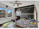 Bright bedroom with playful decor, featuring a unique bed frame, ceiling fan, and natural light from the windows at 382 Gracious Way, Henderson, NV 89011