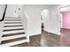 Open entryway with staircase and wood-look flooring that flows into other rooms in the home at 382 Gracious Way, Henderson, NV 89011