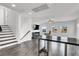 Open-concept living area with wood floors, stairs, and lots of natural light at 382 Gracious Way, Henderson, NV 89011