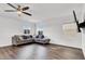 Bright living room with a large window, couch, and ceiling fan at 382 Gracious Way, Henderson, NV 89011