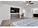 Main bedroom featuring carpet, dresser, TV, ceiling fan, and ensuite bathroom at 382 Gracious Way, Henderson, NV 89011