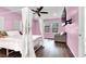 Cozy main bedroom with hardwood floors, natural light, ceiling fan, and an accent wall at 382 Gracious Way, Henderson, NV 89011