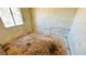 This bedroom provides natural light from the window and has damaged floors at 3974 Palos Verdes St, Las Vegas, NV 89119