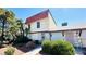 An inviting townhome with mature landscaping, a red tile roof, and a lush curb appeal at 3974 Palos Verdes St, Las Vegas, NV 89119