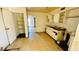 Kitchen needing renovation with worn cabinetry, damaged ceiling, and hardwood floors at 3974 Palos Verdes St, Las Vegas, NV 89119