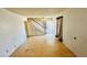A vacant living room needing renovation, featuring a staircase and natural light at 3974 Palos Verdes St, Las Vegas, NV 89119