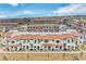 Wide aerial view of a large community of townhomes with tile roofs and desert landscaping at 4 Lomita Heights Dr, Las Vegas, NV 89138