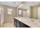 Bathroom with double vanity, large mirror and tiled shower at 4 Lomita Heights Dr, Las Vegas, NV 89138