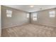 Spacious bedroom featuring three windows and neutral-colored carpet at 4 Lomita Heights Dr, Las Vegas, NV 89138