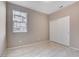 Simple bedroom with a window and sliding door closet showcasing neutral paint and tile floors at 4 Lomita Heights Dr, Las Vegas, NV 89138