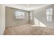 Bright, carpeted bedroom featuring two windows and neutral walls at 4 Lomita Heights Dr, Las Vegas, NV 89138