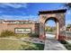 Community sign for Santa Rosa with a brick wall, archway, and lush green grass at 4 Lomita Heights Dr, Las Vegas, NV 89138