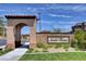 Inviting Santa Rosa community entrance with detailed brickwork and lush landscaping, under a clear blue sky at 4 Lomita Heights Dr, Las Vegas, NV 89138