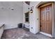 Exterior view of a front entry with brick pavers and a paneled front door at 4 Lomita Heights Dr, Las Vegas, NV 89138