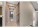 Hallway with tiled flooring leading to a carpeted bedroom with windows at 4 Lomita Heights Dr, Las Vegas, NV 89138