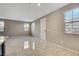 Spacious living room with large windows bringing in natural light and neutral color walls at 4 Lomita Heights Dr, Las Vegas, NV 89138