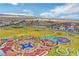 Aerial view of a community playground with unique play structures, covered seating, and plenty of green space at 4 Lomita Heights Dr, Las Vegas, NV 89138