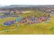 Aerial view of a colorful and modern community playground with unique play structures and green spaces at 4 Lomita Heights Dr, Las Vegas, NV 89138