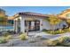 Exterior shot of a gated community pool with a modern building, desert landscaping and pool access at 4 Lomita Heights Dr, Las Vegas, NV 89138