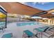 Relaxing community pool area with modern lounge chairs, shaded seating, and a refreshing pool view at 4 Lomita Heights Dr, Las Vegas, NV 89138