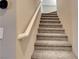 Carpeted stairway with a white handrail leading to the upper level at 4 Lomita Heights Dr, Las Vegas, NV 89138