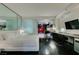 Modern bedroom featuring a sleek white bed, dark wood floors, and a mirrored accent wall at 4381 Flamingo Rd # 2612, Las Vegas, NV 89103