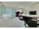 Well-lit bedroom featuring a partial kitchen and desk area with dark wood floors at 4381 Flamingo Rd # 2612, Las Vegas, NV 89103
